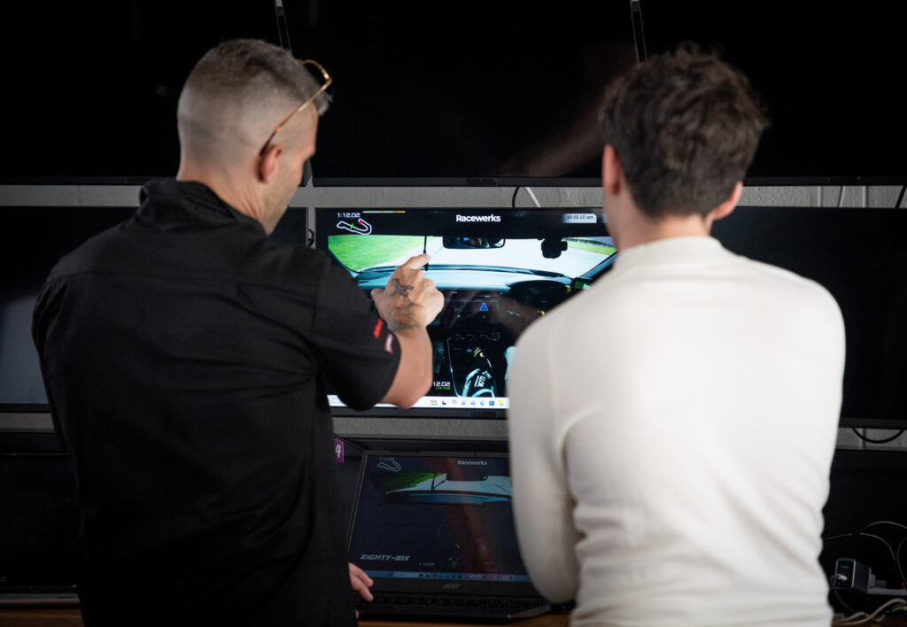 Reviewing telemetry data on track during an Eighty-Six Challenge coaching debrief