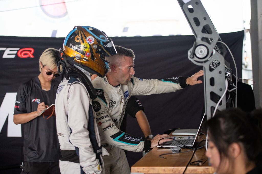 Jono Lester coaching trackside in the pit garage